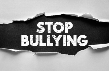 Yırtık kağıt arkaplanından ortaya çıkan kalın tipografideki BÜYÜK BÜYÜK mesajı. Zorbalığa karşı farkındalık, saygı, nezaket ve empati kavramı pozitif sosyal davranışı teşvik eder.