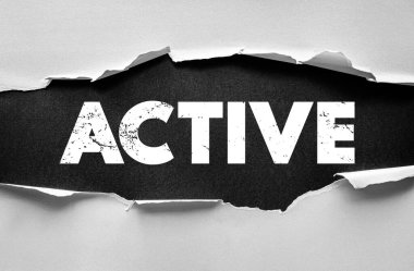 ACTIVE word displayed through ripped paper surface, symbolizing energy, movement, motivation, lifestyle, productivity, and engagement in personal and professional activities