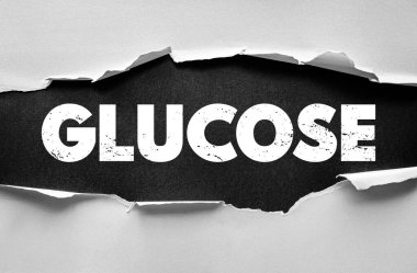 Yırtık kağıt arkaplan üzerine GLUCOSE metni, şeker, enerji, metabolizma ve sağlığı sembolize eden, bilimsel, tıbbi veya besin temelli eğitim materyalleri için uygun