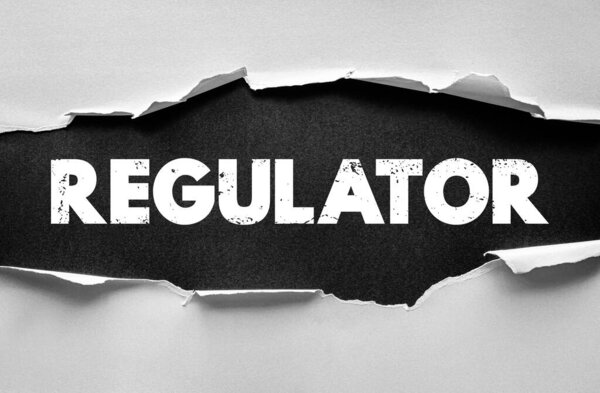 REGULATOR text beneath torn paper. Concept image for control, governance, supervision, compliance, law enforcement, and authority within organizational or market systems