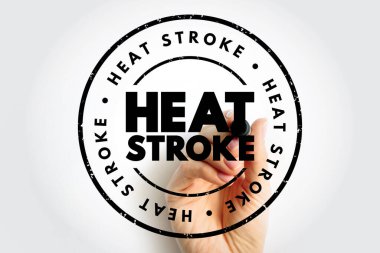 Elle tutulan ısı pulu, tehlike farkındalığı kampanyası ve tıbbi önleme için temiz arka planda izole edilmiş dairesel mühür içerisindeki kalın tipografide acil sağlık terimini gösteriyor.