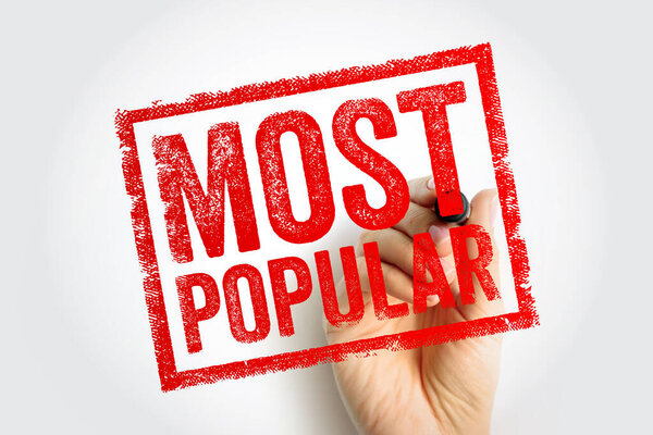 MOST POPULAR stamp text presented as bold typography imprint, hand holding marker creating approval style sign, concept of trend leadership, consumer choice, ranking, demand, promotion, marketing signal