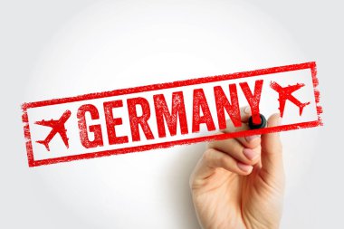 GERMANY seyahat pulu metni dikdörtgen çerçevede, kırmızı mürekkep işareti uçak sembolleri, el yazısı, turizm konsepti resmi varış damgası olarak sunulan ülke adı
