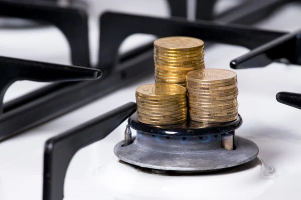 Coin pile on gas burner — Stock Photo, Image
