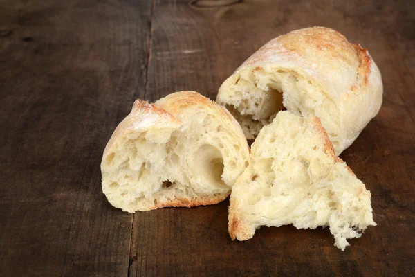 Rustic bread on old wood — Stock Photo, Image