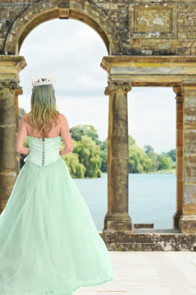 Princess waiting by castle lake — стоковое фото