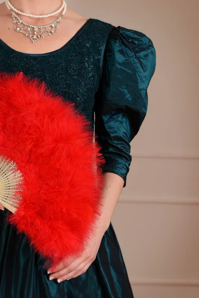 Vintage woman holding red feather fan — Stock Photo, Image