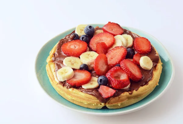 mixed fruit with chocolate spread on a waffle