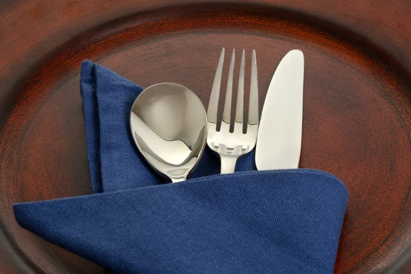 Silverware in blue napkin — Stock Photo, Image