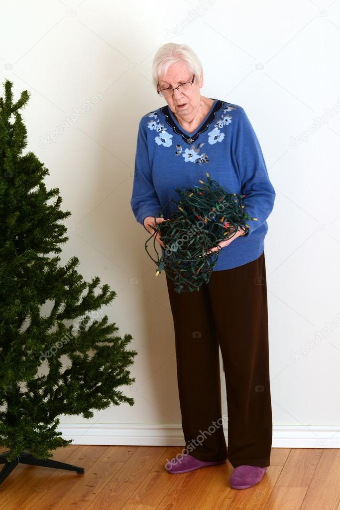 Senior trying to untangle christmas lights