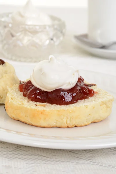 Closeup of scone with cream and jam — Stock Photo, Image