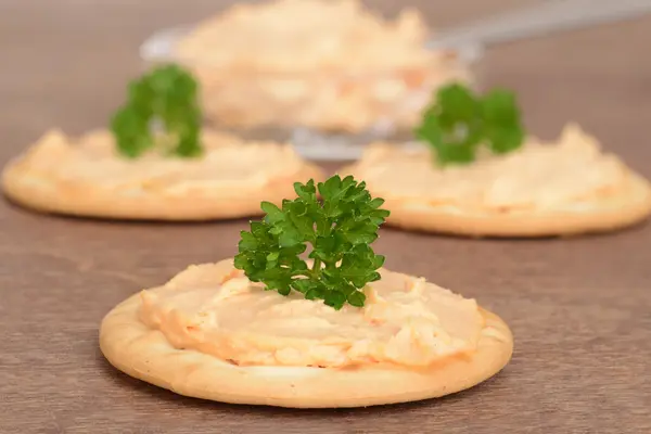 Cracker with salmon pate on wood — Stock Photo, Image