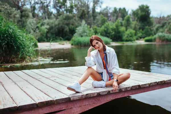 Beautiful Brunette White Shirt Denim Shorts Sits Wooden Bridge Concept — Stock Photo, Image