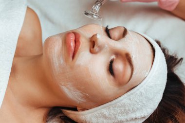 vacuum facial massage .the concept of cosmetology and spa .brunette model