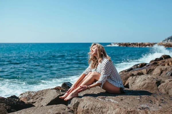 Girl White Blouse Sits Stones Sea — Stockfoto