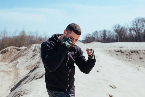 pumped up boxer works out on the sand