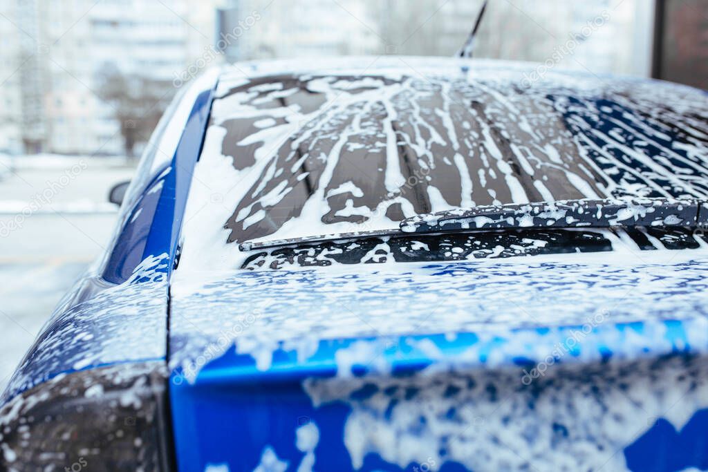 soap foam drips down the glass. self-service car wash