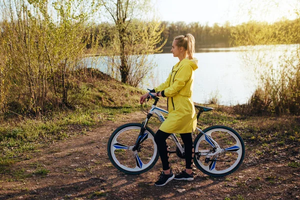 Woman Bike Yellow Raincoat Forest Sport Recreation Concept — Zdjęcie stockowe