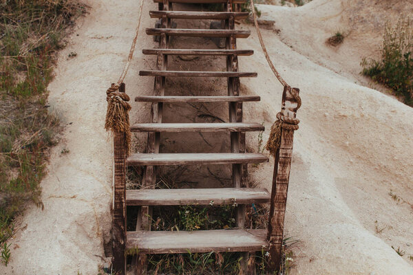 authentic wooden staircase on a mountainside in cappadocia