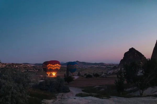 inflating hot air balloons at night