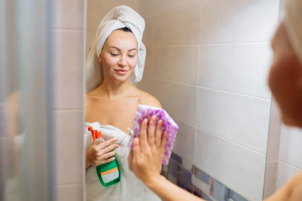 샤워실 청소하고 아름다운 소녀가 헝겊으로 거울을 — 스톡 사진