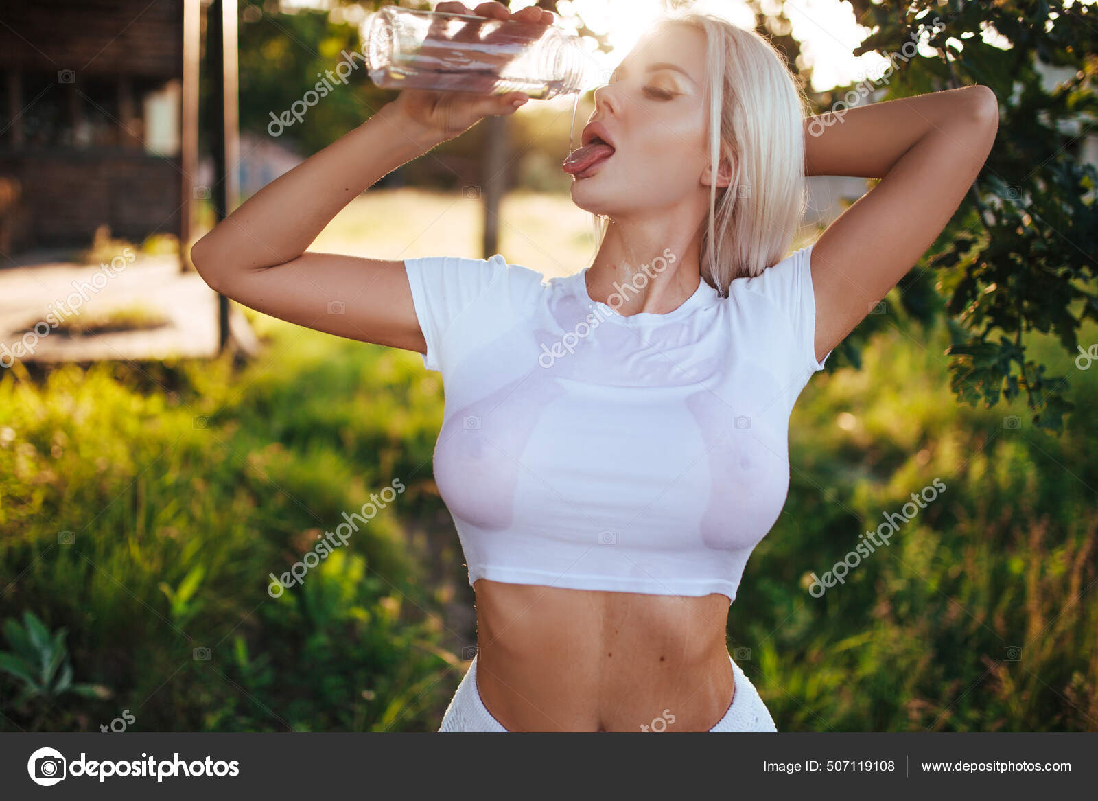 Sexy blonde in a wet T-shirt from which large breasts are visible