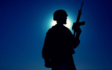 Tüfekli askerin gece silueti.