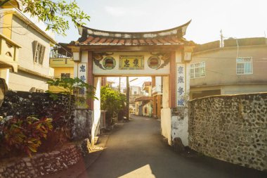 West Bar Gate of Jiadong township, Pingtung county, taiwan. Translation: Chartered Loyalist, do not forget hometown, be friendly with different nation. clipart