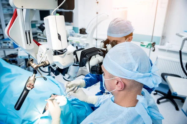 Un equipo de cirujanos que realizan una cirugía cerebral para extirpar un tumor. — Foto de Stock