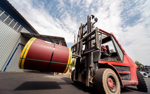 The forklift is handling big metal coil to warehouse. — Stock Photo, Image