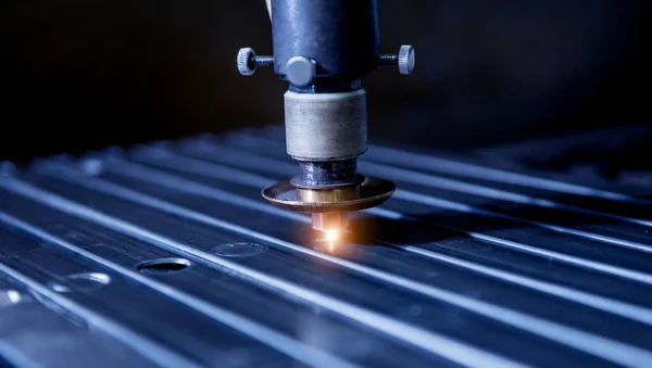 A máquina de corte a laser cortando os furos nos tubos — Fotografia de Stock