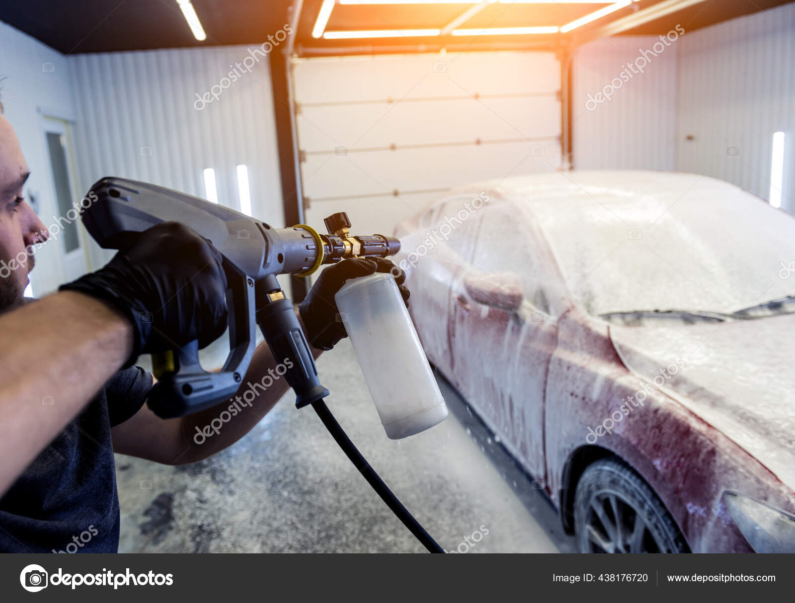Premium Photo  Worker washing car with active foam on a car wash.