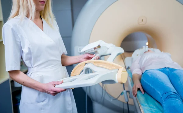 Radiólogo prepara a la mujer joven para un examen cerebral por resonancia magnética — Foto de Stock