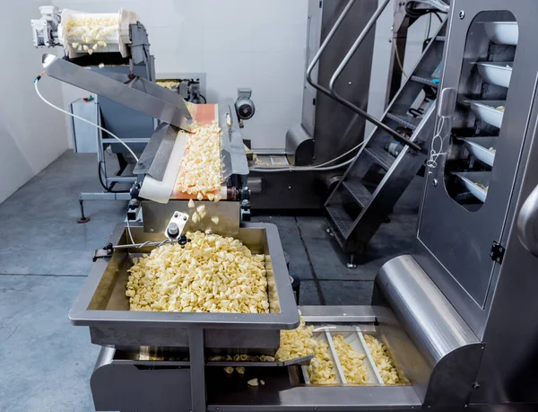 Conveyor line for packing snacks and chips in a modern factory