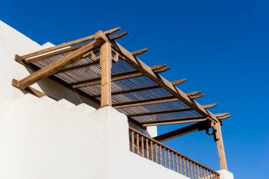 Tropikal bahçedeki en üst katın balkon ve çatılı manzarası.