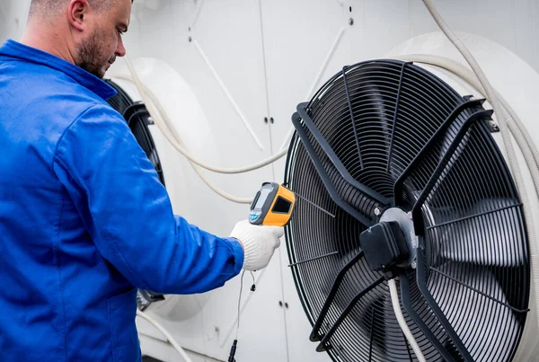 Técnico utiliza un termómetro infrarrojo de imagen térmica para comprobar el intercambiador de calor de la unidad de condensación. —  Fotos de Stock