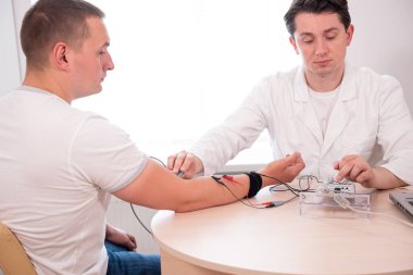 Tıbbi merkezde elektromiyografi kullanan hasta sinirleri test ediliyor.
