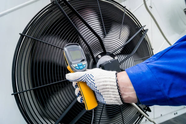 Técnico utiliza un termómetro infrarrojo de imagen térmica para comprobar el intercambiador de calor de la unidad de condensación. —  Fotos de Stock