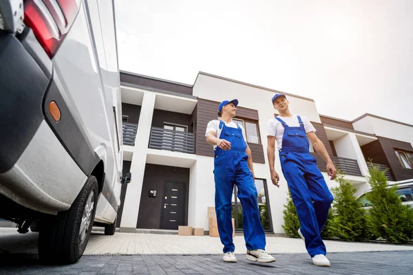 Due operai della società di rimozione che scaricano scatole e mobili dal minibus — Foto Stock