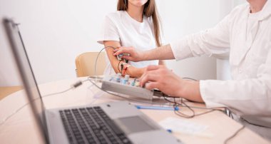 Tıbbi merkezde elektromiyografi kullanan hasta sinirleri test ediliyor.
