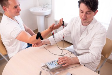 Tıbbi merkezde elektromiyografi kullanan hasta sinirleri test ediliyor.