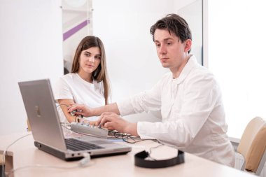 Tıbbi merkezde elektromiyografi kullanan hasta sinirleri test ediliyor.