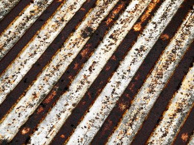 Rusted corrugated metal surface with pronounced diagonal stripes, heavy flaking paint