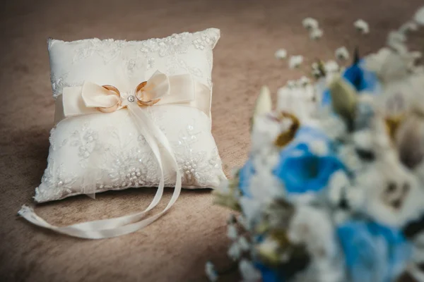 Anelli dorati su cuscino bianco — Foto Stock