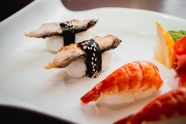 Sushi on white plate — Stock Photo, Image