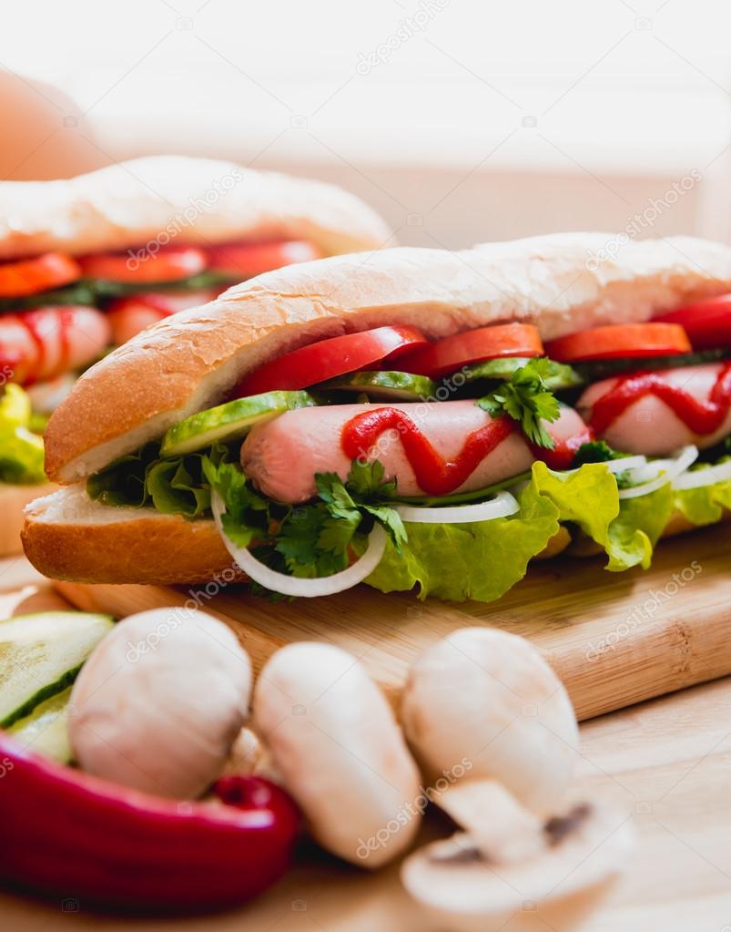 Large hot dogs with vegetables — Stock Photo © Romaset 97333564