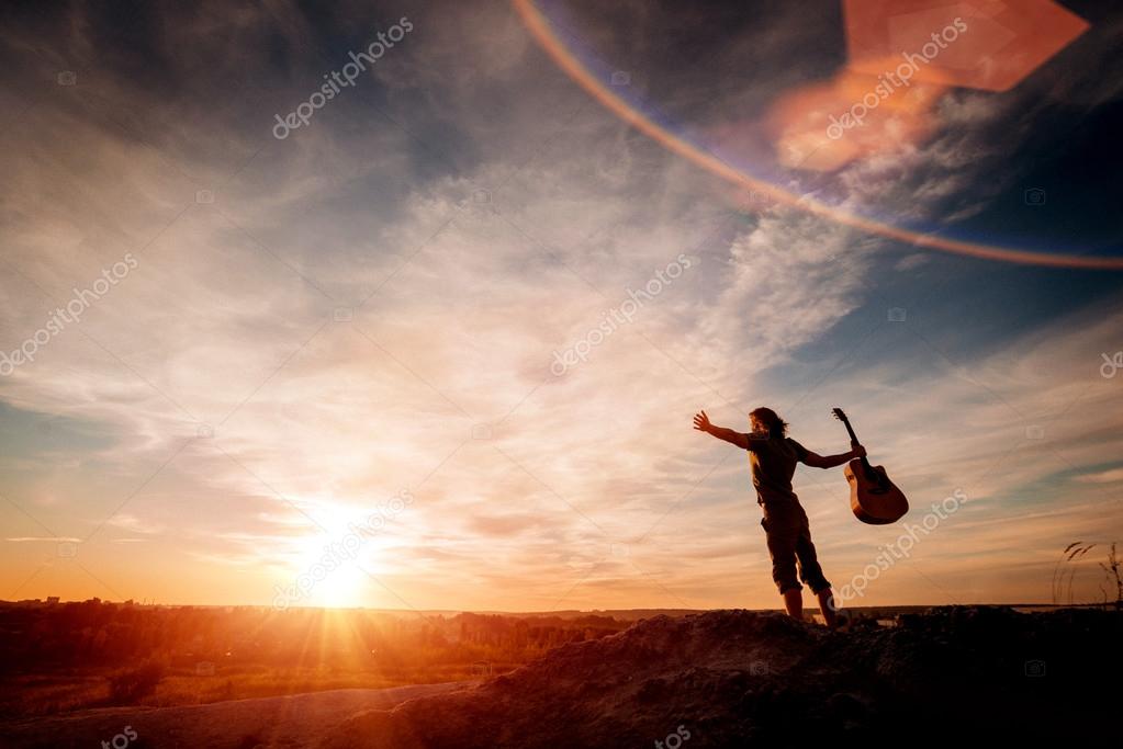 Man with guitar on the mountain — Stock Photo © Romaset 97343430