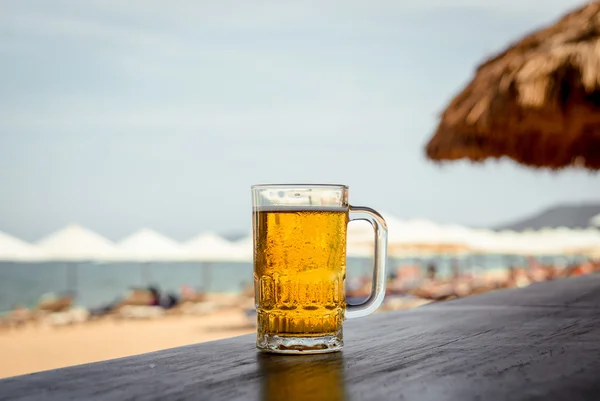 Mug of cold beer with foam