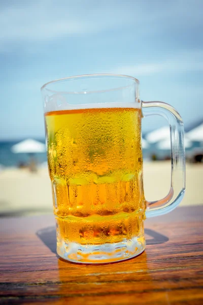 Mug of cold beer with foam Stock Image