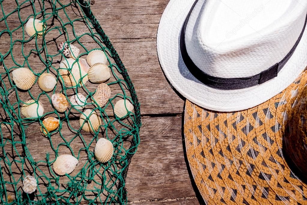 seashells with fishing net and hats 